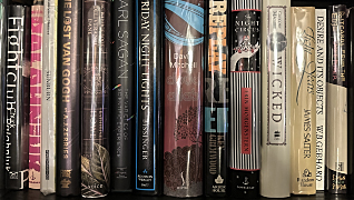 A picture of books on a shelf.